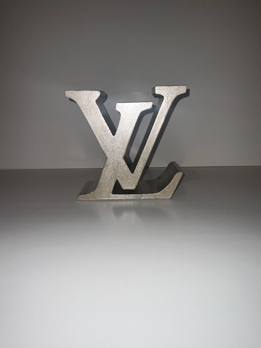 LV Book Holder & Statement Piece: Luxury Meets Functionality Elevate your space with the LV Book Holder, a stunning fusion of luxury and practicality. This oversized, elegantly crafted sign doubles as a functional book holder and a bold statement piece, m